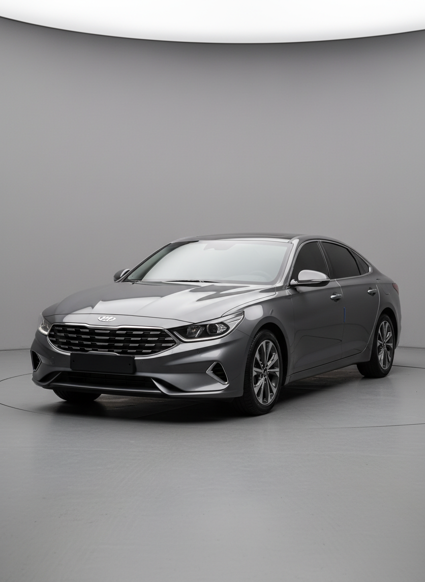 A sleek, modern Korean sedan in metallic graphite gray parked diagonally in a spotless indoor studio, its bodywork perfectly clean and reflective. The camera captures a three-quarter front view at eye level, showing the bold grille, LED headlights, and sharply sculpted hood lines. Soft, diffused studio lighting from both sides creates controlled reflections along the doors and fenders, emphasizing panel gaps and paint quality. The background is neutral and uncluttered, with a subtle gradient that keeps attention on the car. The atmosphere is professional and analytical, suited for an in-depth review on a Korean automotive blog. Photographic realism, high resolution, with sharp focus across the entire vehicle and a slightly darker, serious tone.